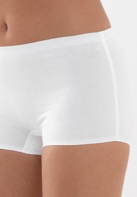 Vita bomullshipster-shorts med en slät textur och elastisk midja, med minimal sömnad och en tät passform.