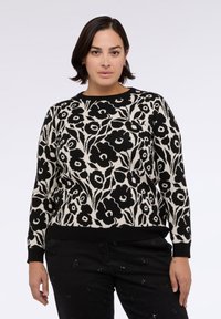 Maglione con motivo floreale in bianco e nero, scollo rotondo e maniche lunghe. Realizzato in morbido tessuto a maglia, presenta polsini e orlo a coste neri.
