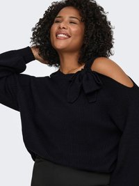 Pull noir en maille avec une coupe ample, présentant un design découpé aux épaules et un nœud sur un côté. Texture douce et motif côtelé.