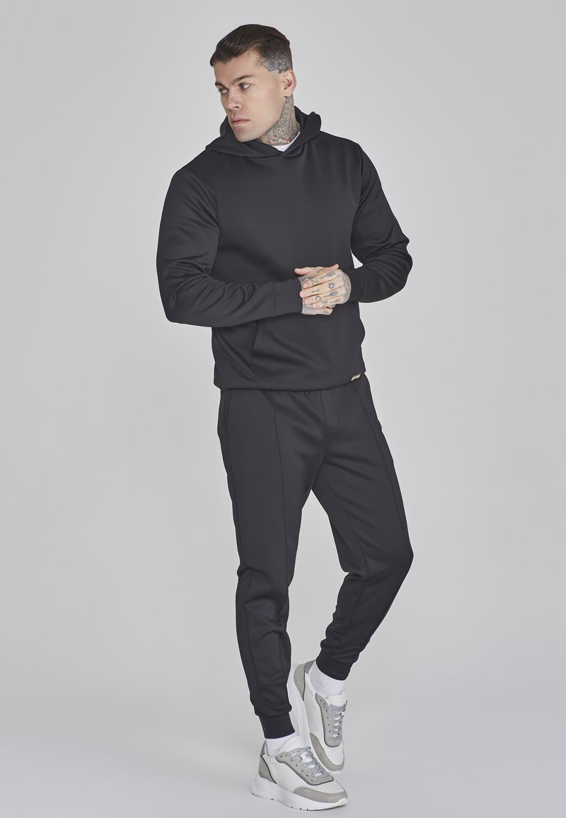 Under Armour ARMOUR FLEECE - Pantalon de survêtement - black/noir - ZALANDO