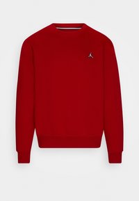 Sudadera roja con cuello redondo, mangas largas y dobladillo acanalado. Presenta un pequeño logo en blanco y negro en el pecho. Textura de tela suave.
