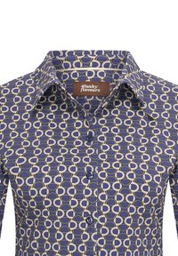 Camisa de botones en azul marino con un patrón geométrico de formas ovaladas en crema y negro. Presenta un collar y botones azules.