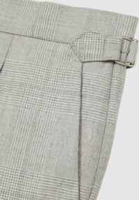 Gray checkered fabric, featuring a textured surface and a side buckle detail. Tailored shape with pleats at the waist for fit adjustment.