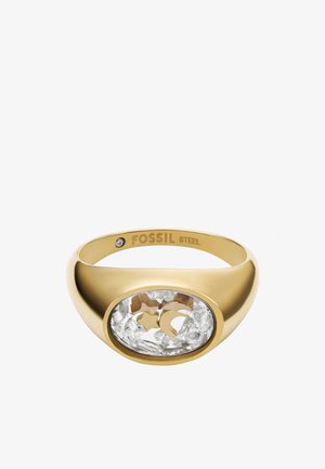 Gold-tone metal ring with a large oval transparent section featuring star and moon shapes, surrounded by clear crystals. Engraved "FOSSIL STEEL."