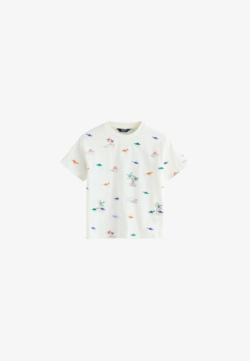 T-shirt bianca a maniche corte con piccoli motivi colorati di dinosauri e palme sparsi sul tessuto.