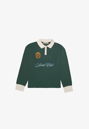 Green long-sleeve polo shirt with a cream collar. Features an embroidered gold crest and blue “Social Club” text on the front.