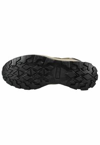 Suela de zapato de goma negra con un patrón de textura profundo y tonos claros en el borde superior, diseñada para ofrecer tracción y estabilidad.