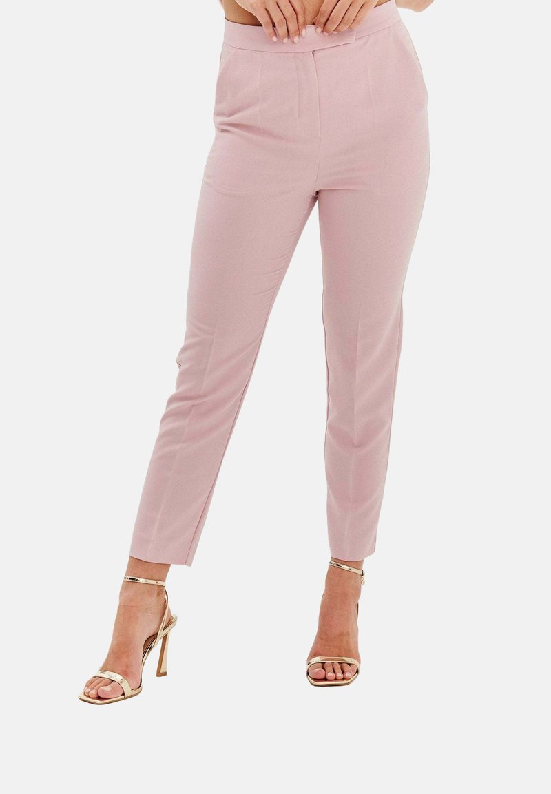 Jasnoróżowe spodnie o dopasowanym kroju, z płaskim przodem i mankietami. W połączeniu z metalicznymi sandałami na wysokim obcasie.