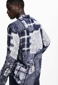Men's long-sleeve shirt features a patchwork design with plaid and bandana patterns in shades of blue and white, cotton fabric, straight collar.