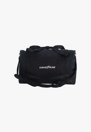 Black duffel bag made of durable fabric, featuring two handles and an adjustable shoulder strap. Displays "GOODYEAR" logo in white.