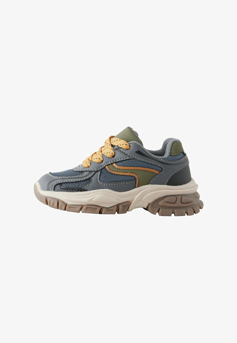 Gray sneaker with olive green accents, textured mesh and synthetic upper, beige laces, and a chunky rubber sole with traction grooves.