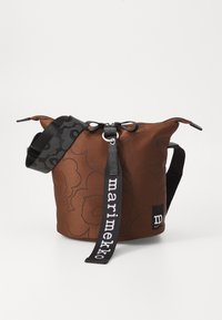 Brown bucket bag with floral pattern, adjustable black strap featuring the text "marimekko," cinched top design, and fabric texture.