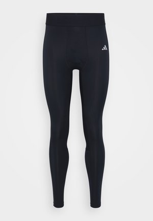 Sorte atletiske leggings i fuld længde med høj talje og lille hvid Adidas-logo på øverste venstre lår.