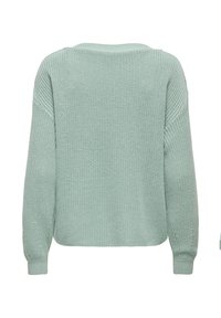 Pull en maille vert clair à manches longues, poignets côtelés et coupe ample, présenté de dos sur un fond blanc.