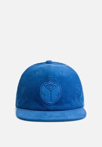 Blue corduroy cap with a flat brim. Features an embroidered logo on the front. Smooth texture, structured design, and six panel construction.