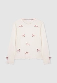 Camicia bianca a maniche lunghe con fiocchi rosa posizionati uniformemente sul davanti e sulle maniche, caratterizzata da un collo rotondo e orli ondulati.