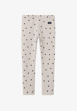 Hellbeige Leggings mit schwarzen Punkten. Sie verfügen über einen elastischen Bund und ein kleines navyblaues Etikett mit der Aufschrift "P.O.P." an der Seite.