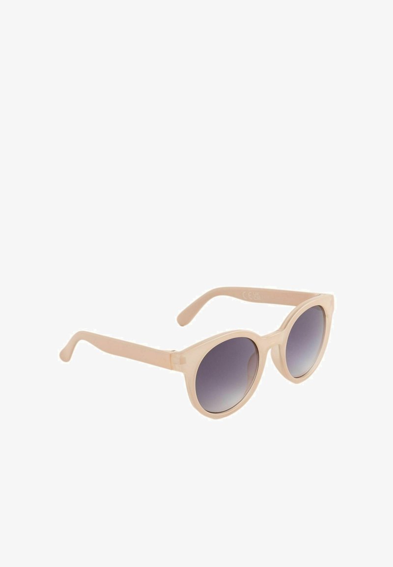 Lunettes de soleil rondes avec une monture beige clair et des verres dégradés foncés. Texture lisse avec des branches fines et courbées. Aucun élément visible de quincaillerie ou d'ornement.