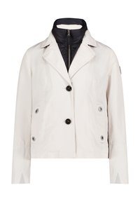 White jacket with a structured collar, black zippered inner layer, two front pockets, and large black buttons on the front.