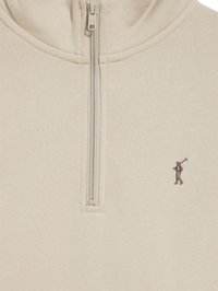 Pullover beige con zip a un quarto e figura di golf ricamata. Tessuto morbido con una consistenza liscia, caratterizzato da dettagli di cucitura minimi.