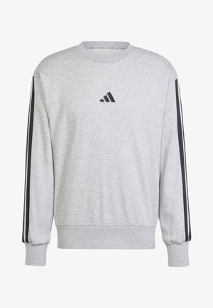 Harmaa collegepaita, joka on valmistettu pehmeästä kankaasta. Siinä on pyöreä kaula-aukko, ribbikuvioidut hihansuut ja mustat sivuraidat. Edessä on Adidas-logo.