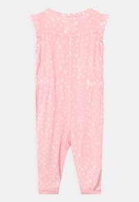 Rosa blommig jumpsuit med korta ärmar, elastiskt midjeband och ankelfållar. Tillverkad av mjukt tyg med ett spritt mönster av vita blommor.