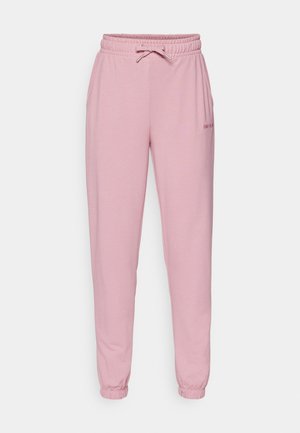 Rosa joggebukser laget av mykt stoff har elastisk midje med snor, sidelommer og smale mansjetter ved anklene.