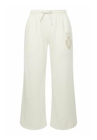 Jasno beżowe długie spodnie dresowe o szerokich nogawkach z elastycznym pasem i sznurkiem. Posiadają subtelną logo w jaśniejszym odcieniu na lewej biodrze.