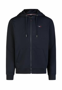 Marineblaue Zip-Hoodie mit Kordelzugkapuze, Fronttaschen und Logoakzent. Hergestellt aus einem glatten, weichen Stoff mit gerippten Bündchen und Saum.