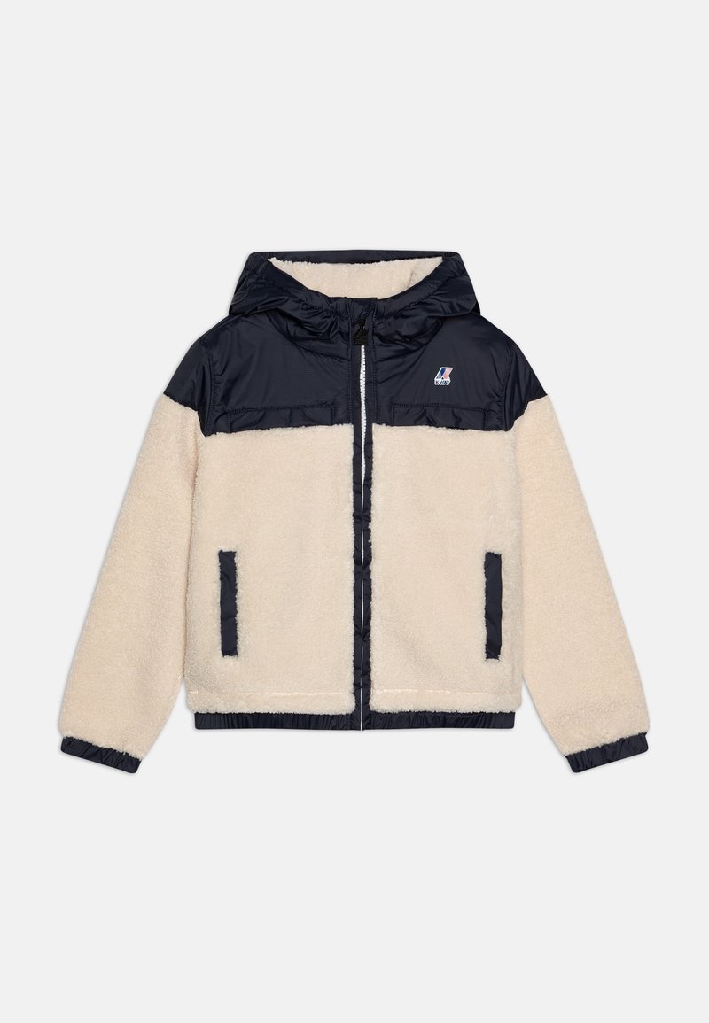 Veste polaire crème avec panneau en nylon noir sur la poitrine, capuche, fermeture éclair devant, poignets élastiques et deux poches latérales.