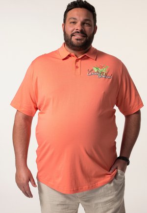Kurzärmliges, kragenloses Poloshirt in leuchtendem Korallenrot mit gesticktem "Exalted Island"-Logo und Blumenmuster auf der linken Brust. Weicher Stoff.