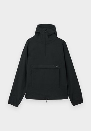 Must mustar jakk, millel on kõrge krae, pool tõmblukk, elastsed mansetid ja eesmine tasku horisontaalse flapi ning sileda kangaga.