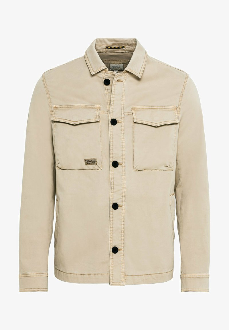 Beige jakke lavet af bomuld med krave, knaplukning, to brystlommer og synlige stikninger.