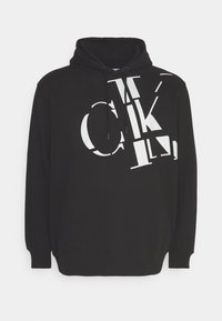 Black hoodie featuring a large white graphic text design, drawstring hood, and ribbed cuffs and hem. Made from soft, comfortable fabric.