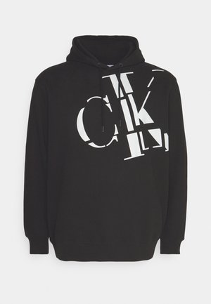 Haut à capuche noir avec un grand design de texte graphique blanc, capuche avec cordon de serrage et poignets et ourlet côtelés. Fabriqué en tissu doux et confortable.