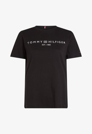 Black cotton t-shirt with short sleeves, featuring white "TOMMY HILFIGER" text and "EST. 1985" beneath. Round neckline, relaxed fit.