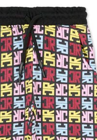 Pantaloni della tuta con motivo che presentano una vita elastica nera e cordoncino. Il tessuto mostra lettere multicolori su uno sfondo scuro.