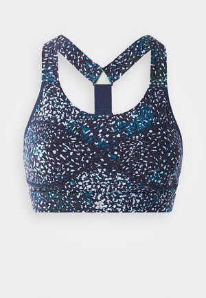 Sportbh met een marineblauwe basis en een multikleurige spikkelpatern, racerback ontwerp en versterkte naden voor ondersteuning.