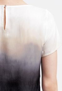 Blusa de seda con un diseño de degradado que va de beige claro a gris oscuro, con un brillo sutil y una pequeña apertura keyhole en la parte posterior.