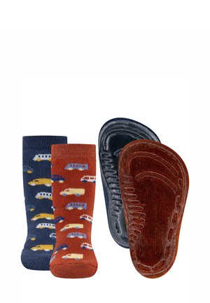 Two pairs of toddler socks, one navy blue and one rust orange, each with colorful car patterns, shown with matching textured non-slip soles.