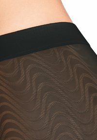 Le legging in pizzo nero presentano un motivo testurizzato e ondulato, con una cintura elastica morbida. Il design è trasparente con una leggera lucentezza.