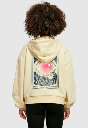 Crème-kleurige hoodie met een grafisch ontwerp op de achterkant, featuring een zon en golven, in blauw, roze en zwart. Zachte stof.