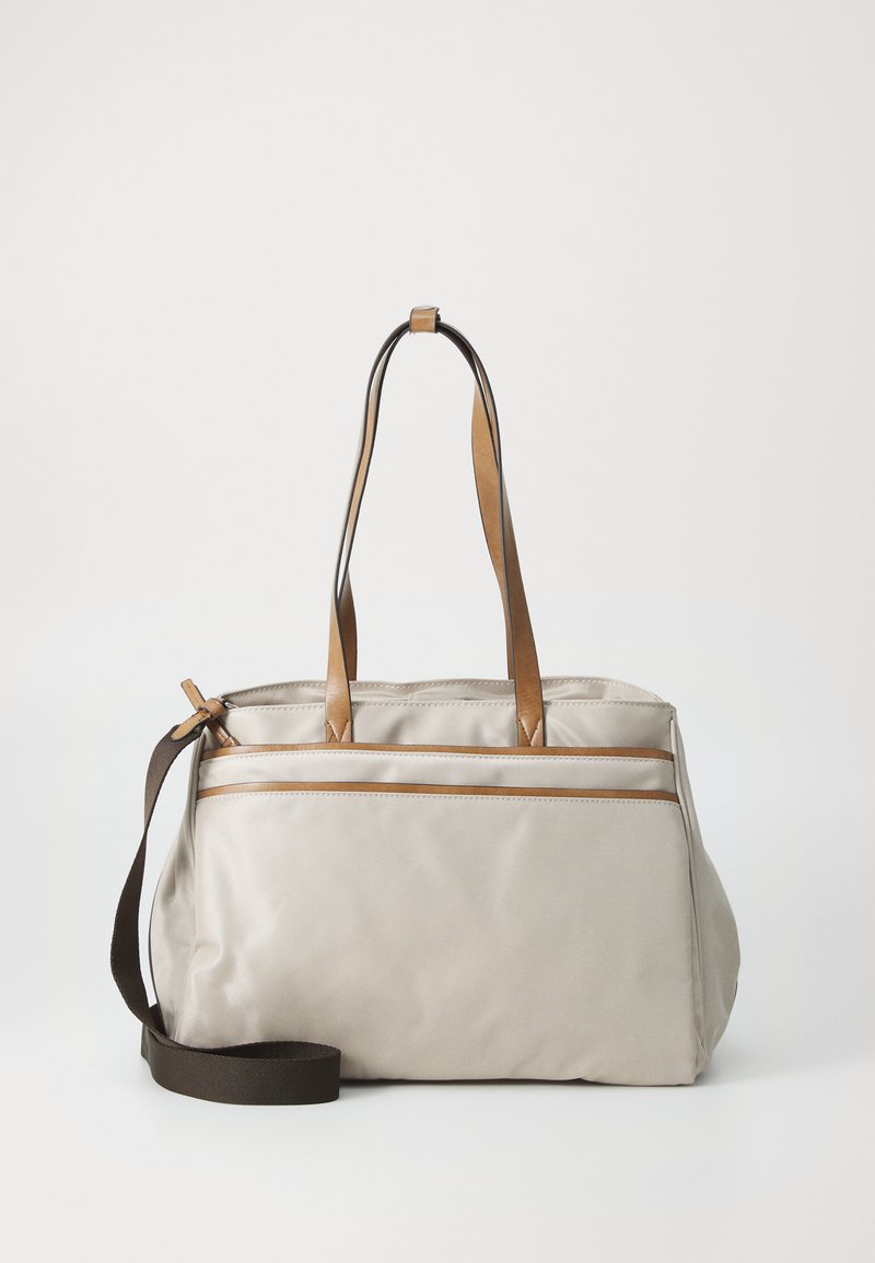 Beige fabric bag with brown leather accents, featuring two top handles and a long adjustable strap. Includes dual zippered pockets.