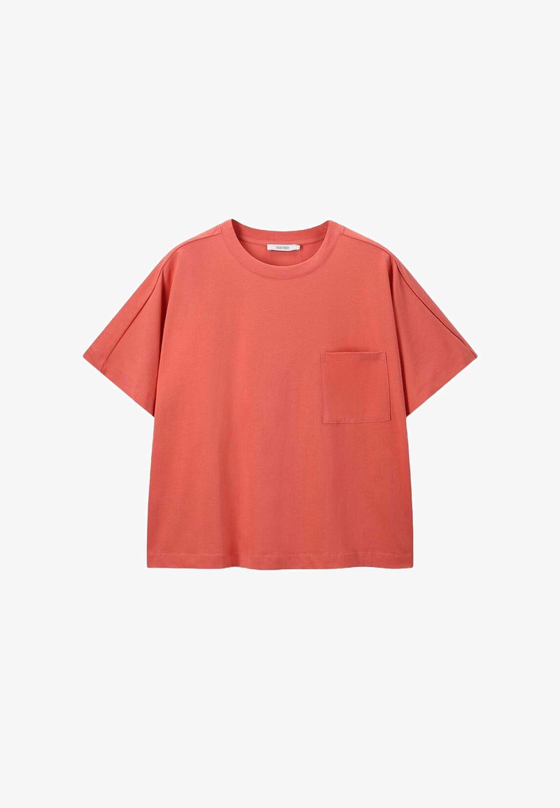 T-shirt corail à manches courtes en coton, avec un col rond et une poche poitrine unique. Coupe décontractée avec épaules tombantes.