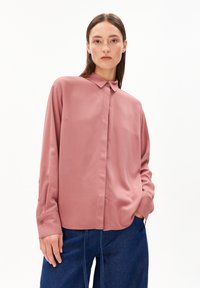 Long-sleeve shirt in soft, dusty rose fabric with a collar, front button closure, and slightly loose fit. Smooth texture and no visible patterns.