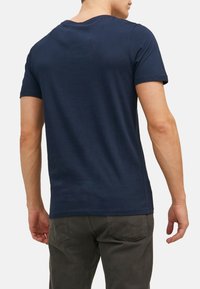 Navy blue cotton t-shirt with short sleeves, crew neck design, smooth texture, and no visible patterns or accents.