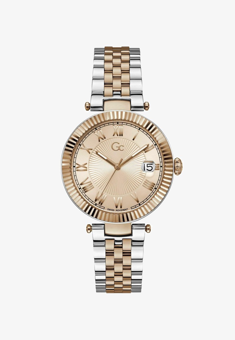 Orologio con finitura oro e argento, dotato di una lunetta scanalata, indicatori in numeri romani e un quadrante texturizzato che mostra una finestra della data alle 3.