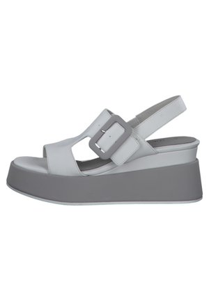 White platform sandal with a thick gray sole, large square buckle, and open toe and heel design.
