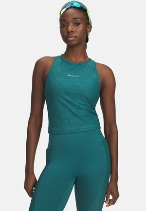 Turkoois cropped top met golfpatroon, logo in het midden, gecombineerd met bijpassende high-waisted leggings met zijzakken en gestructureerde panelen.