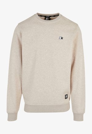 Hellbeige Sweatshirt aus strukturiertem Stoff. Mit Rundhalsausschnitt, gerippten Bündchen und einem kleinen schwarzen Logo auf der Brust.